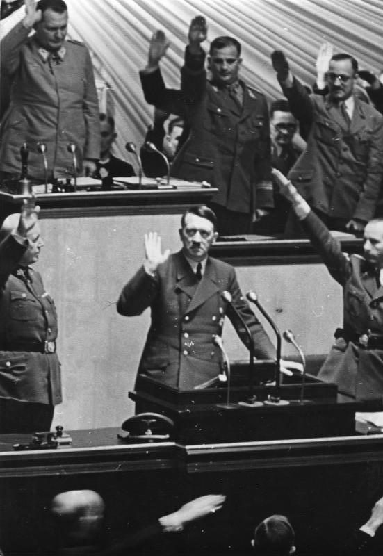 Adolf Hitler salutes the members of the Reichstag after declaring war on America